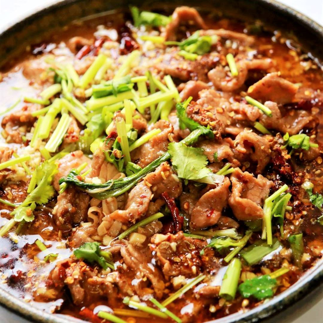 Poached sliced beef and vegetables in hot chili oil