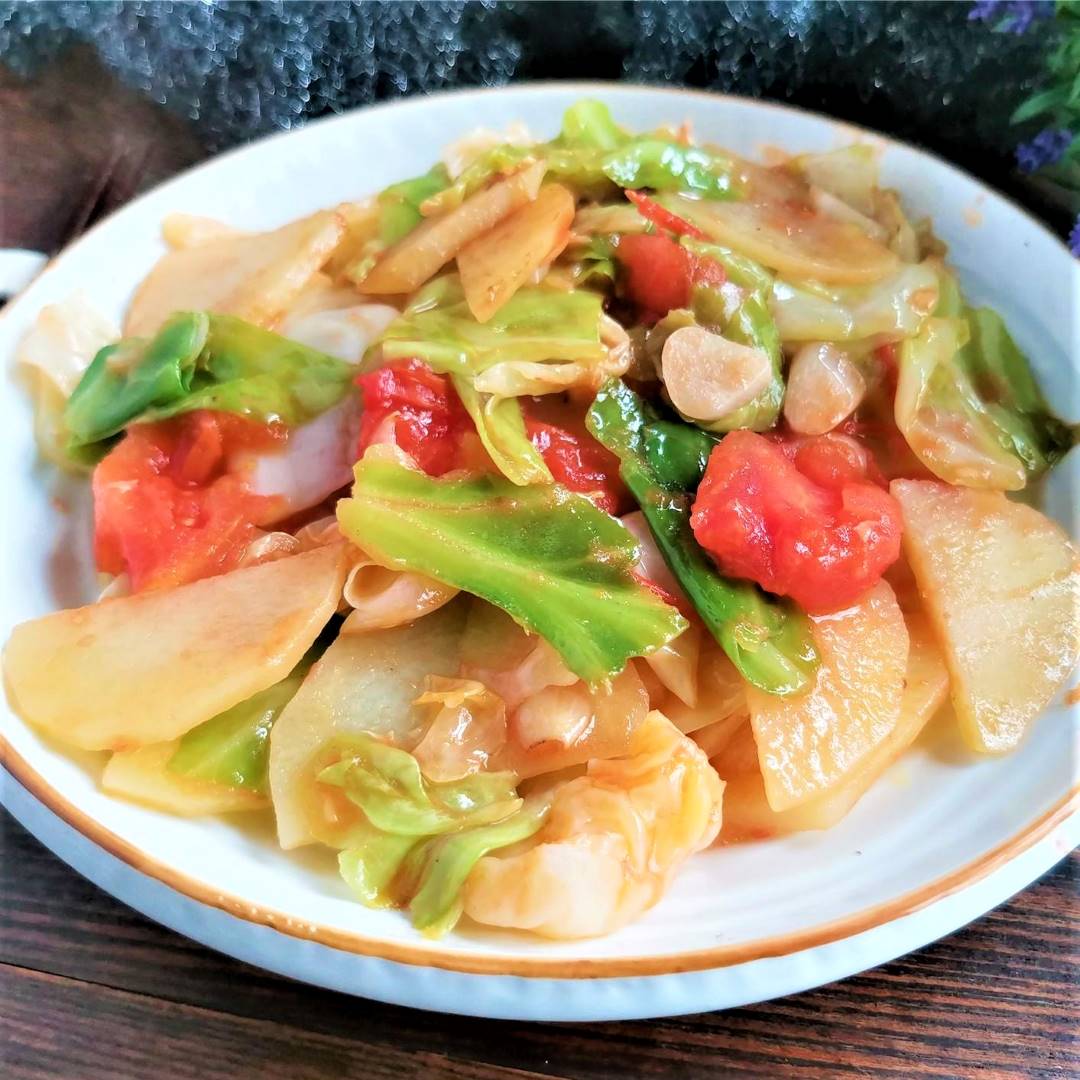 light vegetarian food tomatoes and potatoes Stir-Fry with cabbage