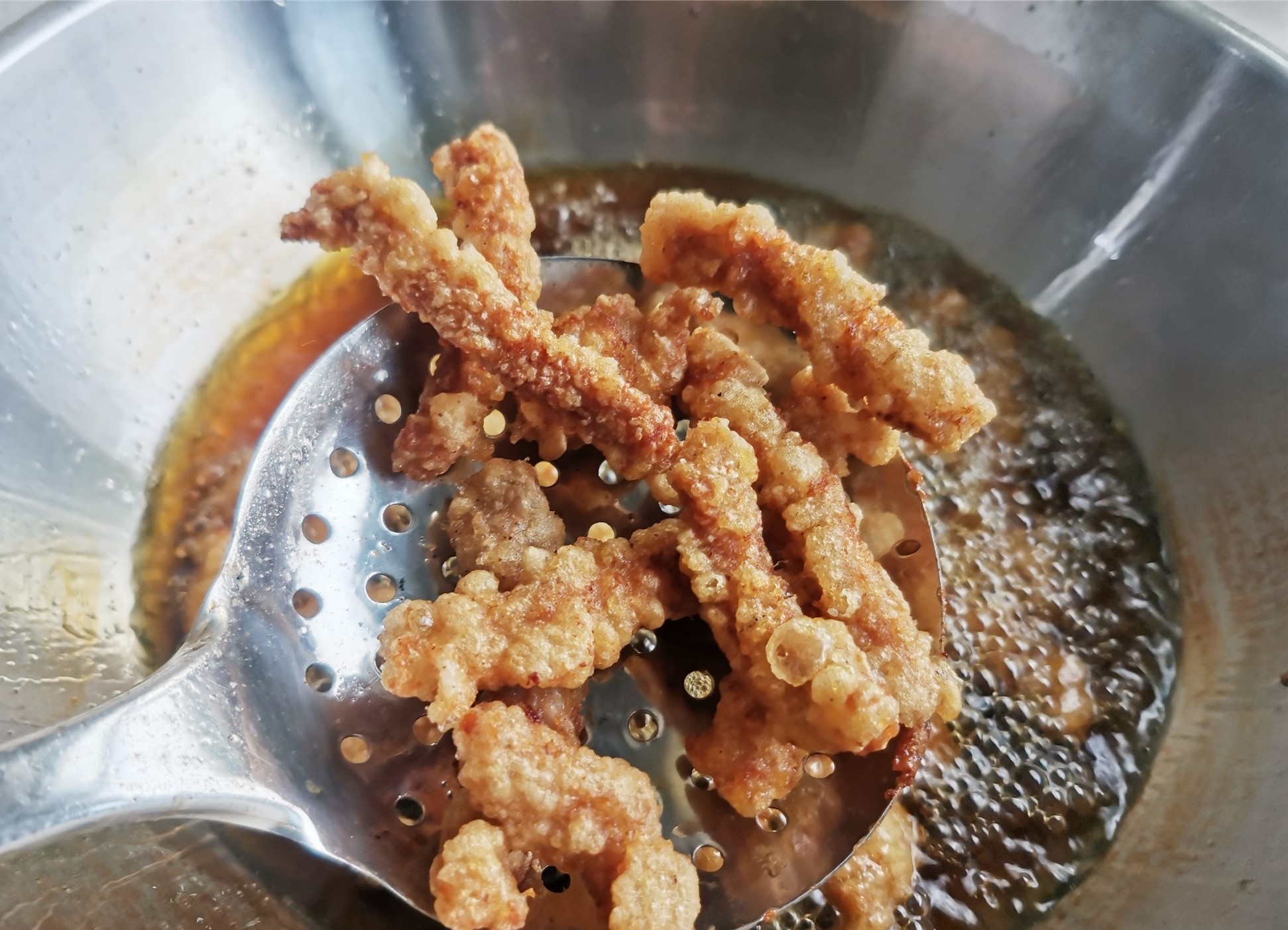 Fry the meat strips until golden brown