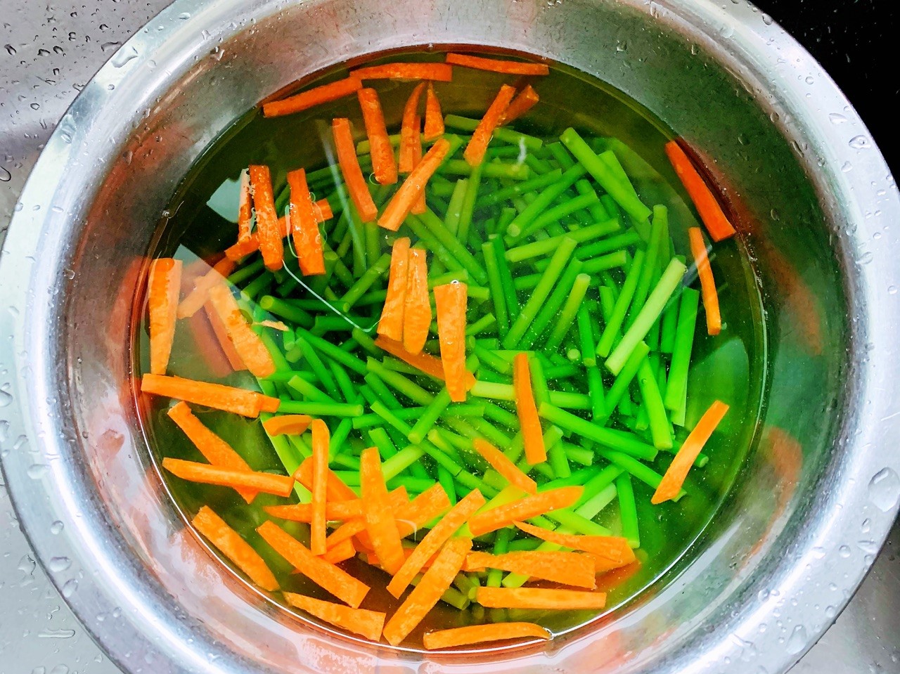 blanch garlic sprouts and carrot for about 1 minute