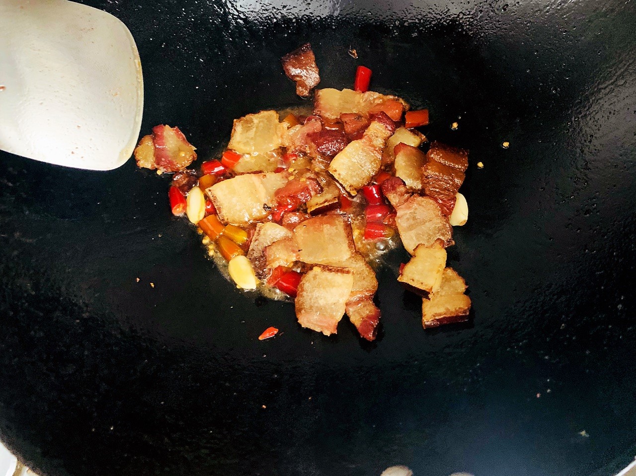 pour in the bacon and stir fry until the oil comes out